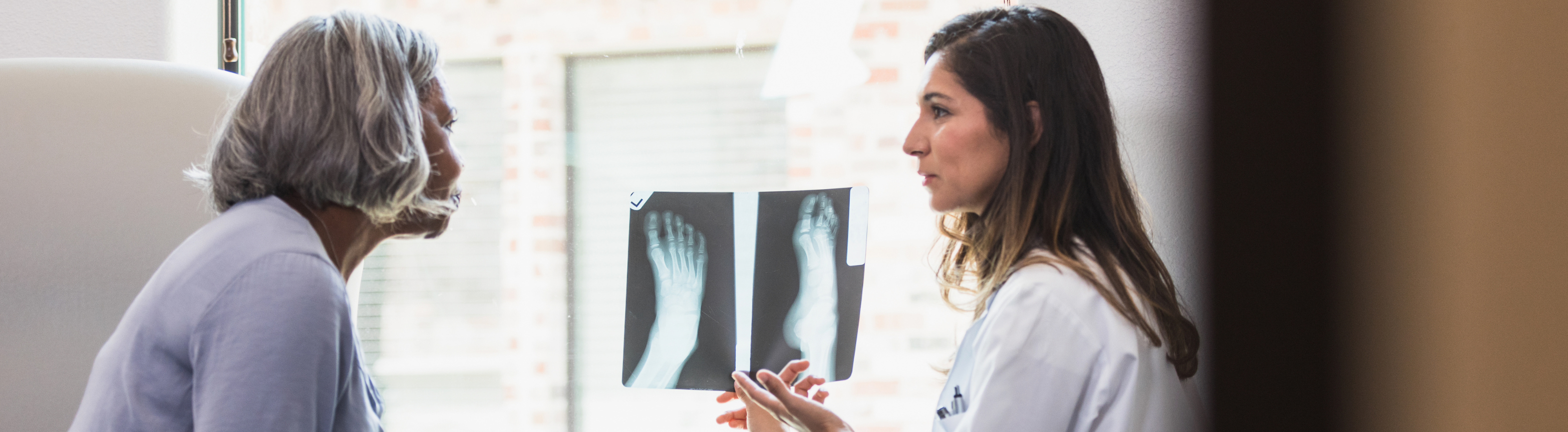Older women getting her lab results checked by a doctor